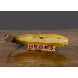 A German clockwork tinplate Zeppelin or Airship, lithographed yellow with red details, integral