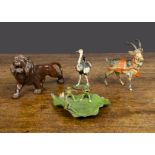A Heyde boy riding ostrich and frog chorus on leaf, a large Lion made in Japan and a German