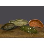 Four Continental pottery moulds, a fish with pale green glazed interior —17½in. (44.5cm.) long; a