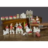 Various bisque cake decorations, Dick Whittington, a seated baby playing an accordion, a frosted