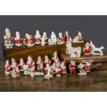 Bisque Father Christmas cake decorations, thirty four examples mainly standing, one driving a