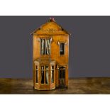 A small late 19th Century English wooden dolls’ house, pine construction with bay window, dummy