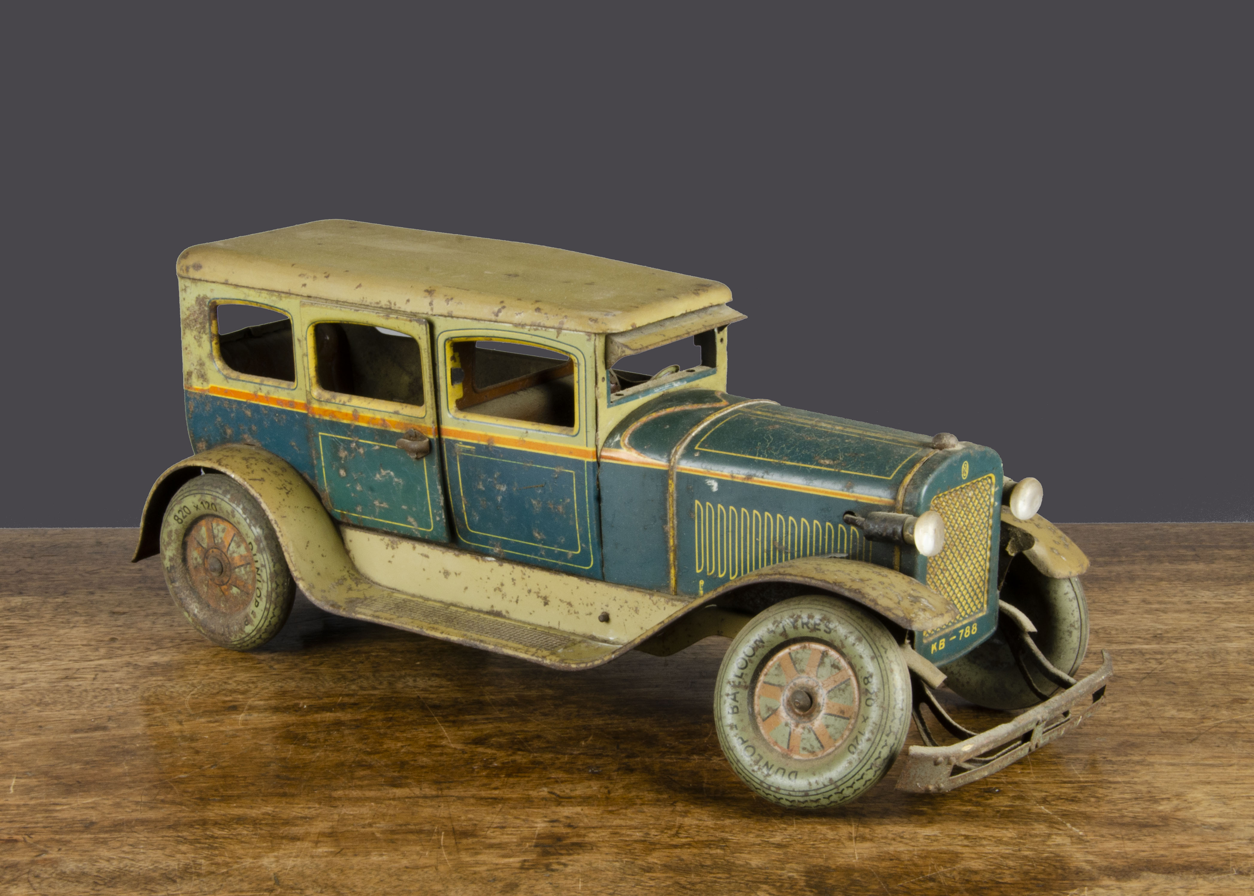 A Karl Bub clockwork tinplate Limousine, lithographed teal and pale green with yellow lining,