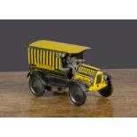 A Wells clockwork tinplate Express Delivery van, lithographed black and yellow stripes, driver and