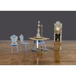 German soft metal dolls’ house items, two blue painted chairs —3in. (7.5cm.) high and matching table