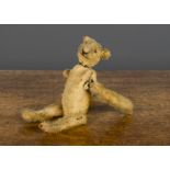 A 1910-20s clockwork somersaulting teddy bear, German or American with short golden bristled mohair,