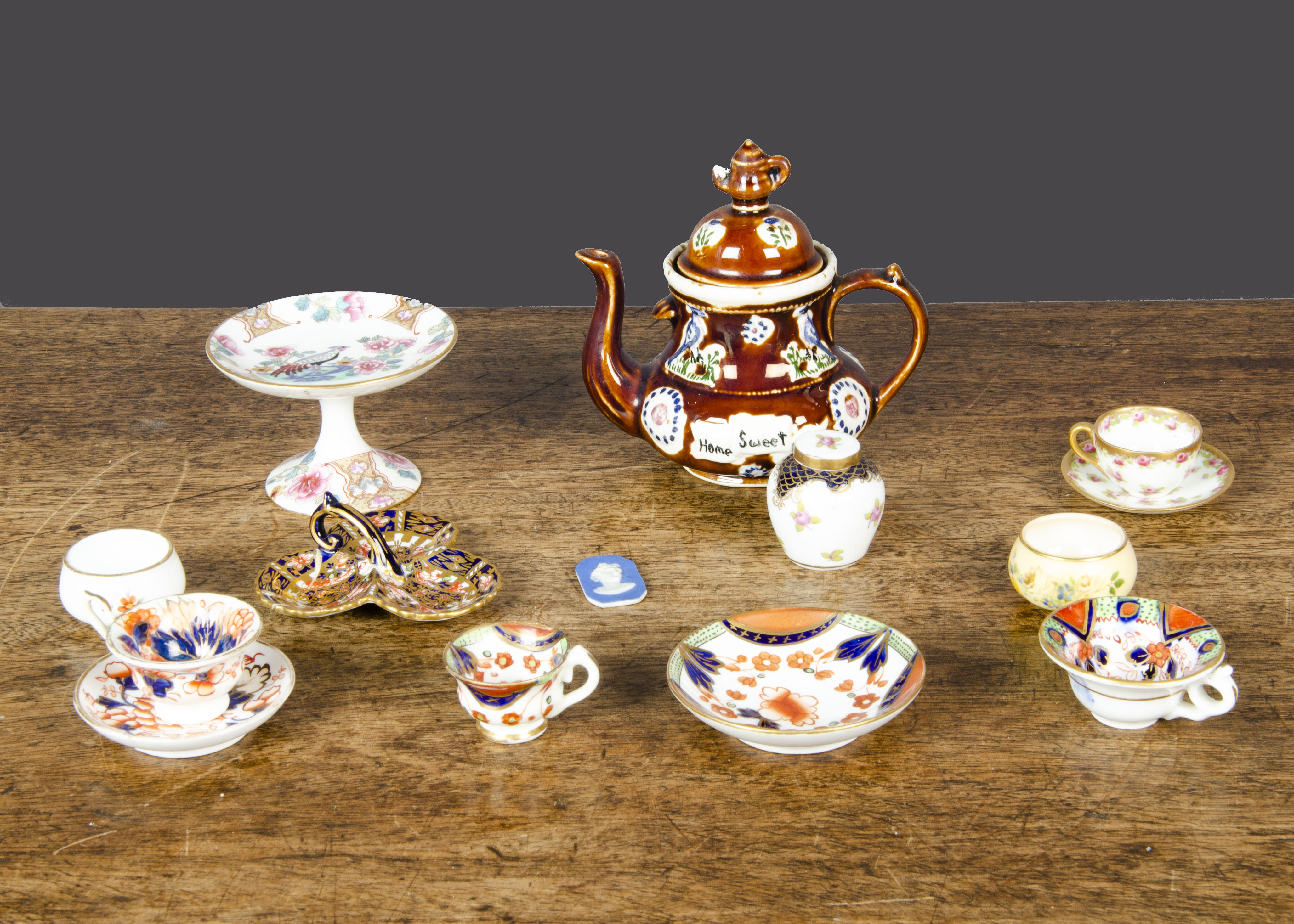 Miniature porcelain, a 19th Century Imari pattern coffee cup, tea cup and saucer; another Imari