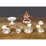 Miniature porcelain, a 19th Century Imari pattern coffee cup, tea cup and saucer; another Imari