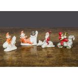 Unusual bisque cake decorations, a dwarf riding a mouse —2¼in. (5.5cm.) long, a red painted