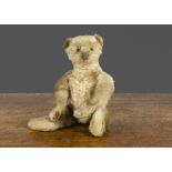 An early Steiff teddy bear with blank button, with blonde mohair, black boot button eyes, pronounced