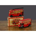 A Wells Brimtoy Stop & Go Trolley Bus, clockwork, in original box —4½in. (11.5cm.) long; and similar