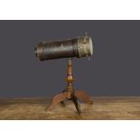 A Charles G Bush & Co (American) kaleidoscope, card covered in brown textured paper, brass end