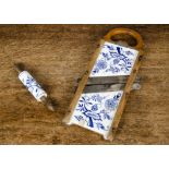 A Meissen Flow Blue Mandolin food slicer, with blue painted porcelain panels on wooden frame,