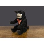 A 1920s jointed mohair Felix the Cat, with short black bristle mohair, white and black glass eyes,