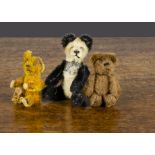 Three Schuco miniature teddy bears, all with metal framed jointed bodies, a panda —3½in. (9cm.)