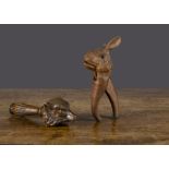 A Black Forest carved-wooden fox head nutcracker, with screw-action handle —7in. (17cm.) long; and a