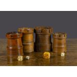 Four 19th Century turned wood castle dice shakers, various woods with crenellations and four die —