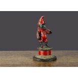 A cast-iron cigar smoking Mr Punch match holder, red painted with large cigar in mouth, a quill in