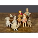 Dolls’ house dolls, a bisque shoulder head maid with blonde moulded hair, stuffed body, bisque limbs