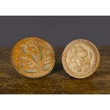 Two wooden butter stamps, one carved with acorns; and the other with flower —4¾in. (12cm.)