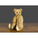 A small early Steiff teddy bear, with apricot mohair, black boot button eyes, pronounced clipped