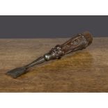 An ornate 19th Century button hole chisel, the hardwood handle carved with leaves and steel tool —