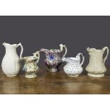 Five 19th Century English pottery jugs, a floral embossed jug with blue spots —5½in. (14cm.) high; a