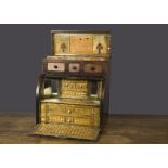 A 19th Century straw-work table top bureau, the body of mahogany with roll-top front, pull-down