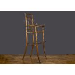 A French faux bamboo doll’s high chair, turned wood with cane seat, indistinctly ink stamped ‘