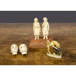 A 19th Century Dieppe carved ivory boy and girl fisher folk group, mounted on a later wooden base —