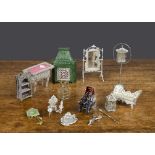Soft metal dolls’ house items, a green painted stove heater with door —3½in. (9cm.) high; a bird