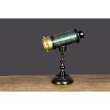 A small late 19th Century kaleidoscope, green lacquered tinplate barrel with ebonised ends, brass