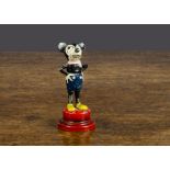 A German lead Mickey Mouse, standing with hands on hips with red base probably originally a tape