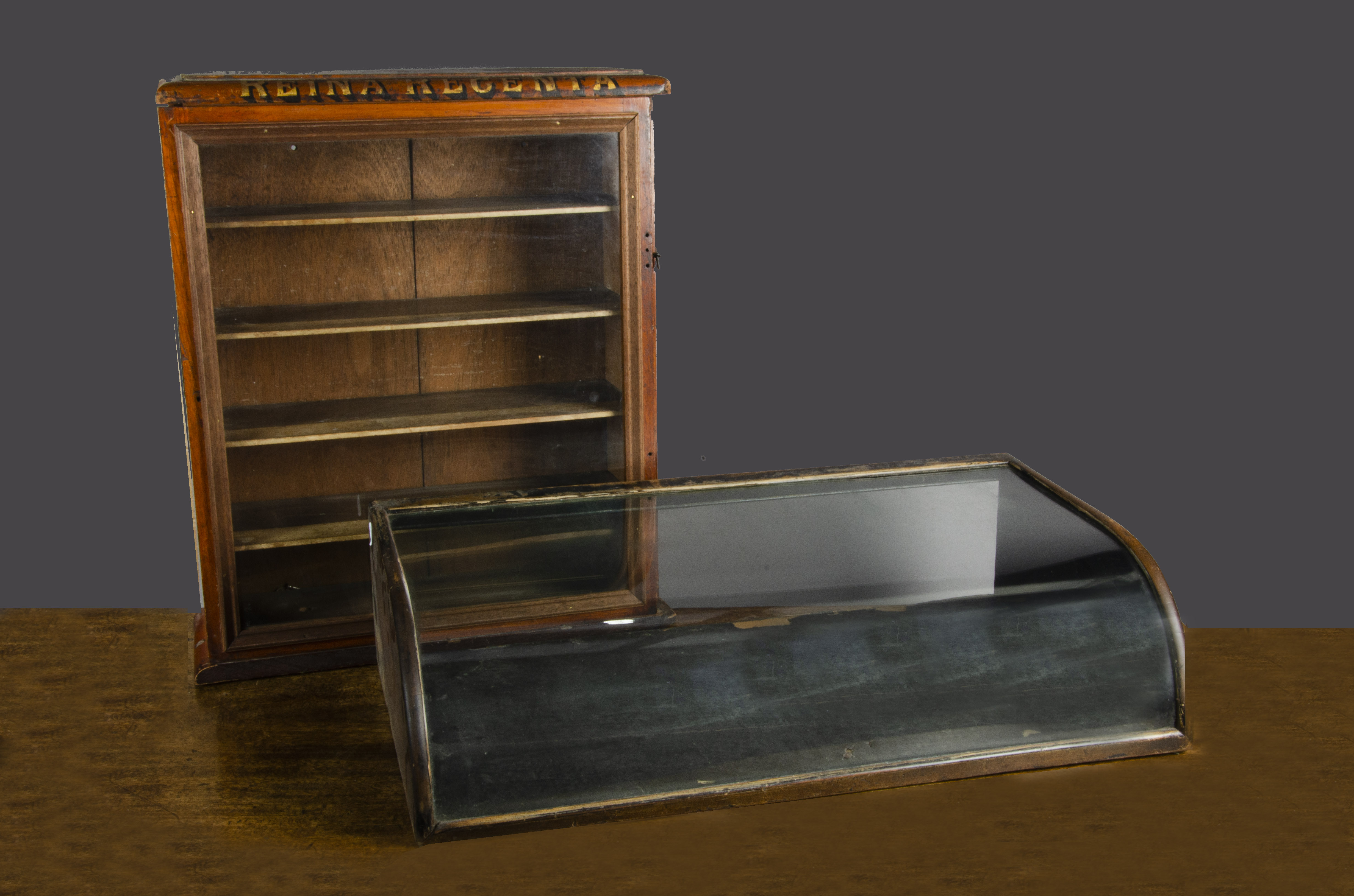 A Reina Regenta display cabinet, painted with gold black-shaded letters, four shelves and modified