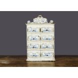 A late 19th Century painted tinplate spice drawer, white with hand-painted blue floral decoration,