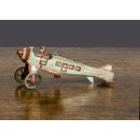 A Kellermann Penny Toy passenger plane, lithographed grey with red linning, brown pilot with