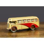 A Wells Brimtoy cream and red single deck bus, clockwork, cream and red lithographed tinplate with