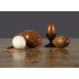 Treen eggs, a turned wood nutmeg grater —2in. (5cm.) high (glue repairs to top half); an egg in