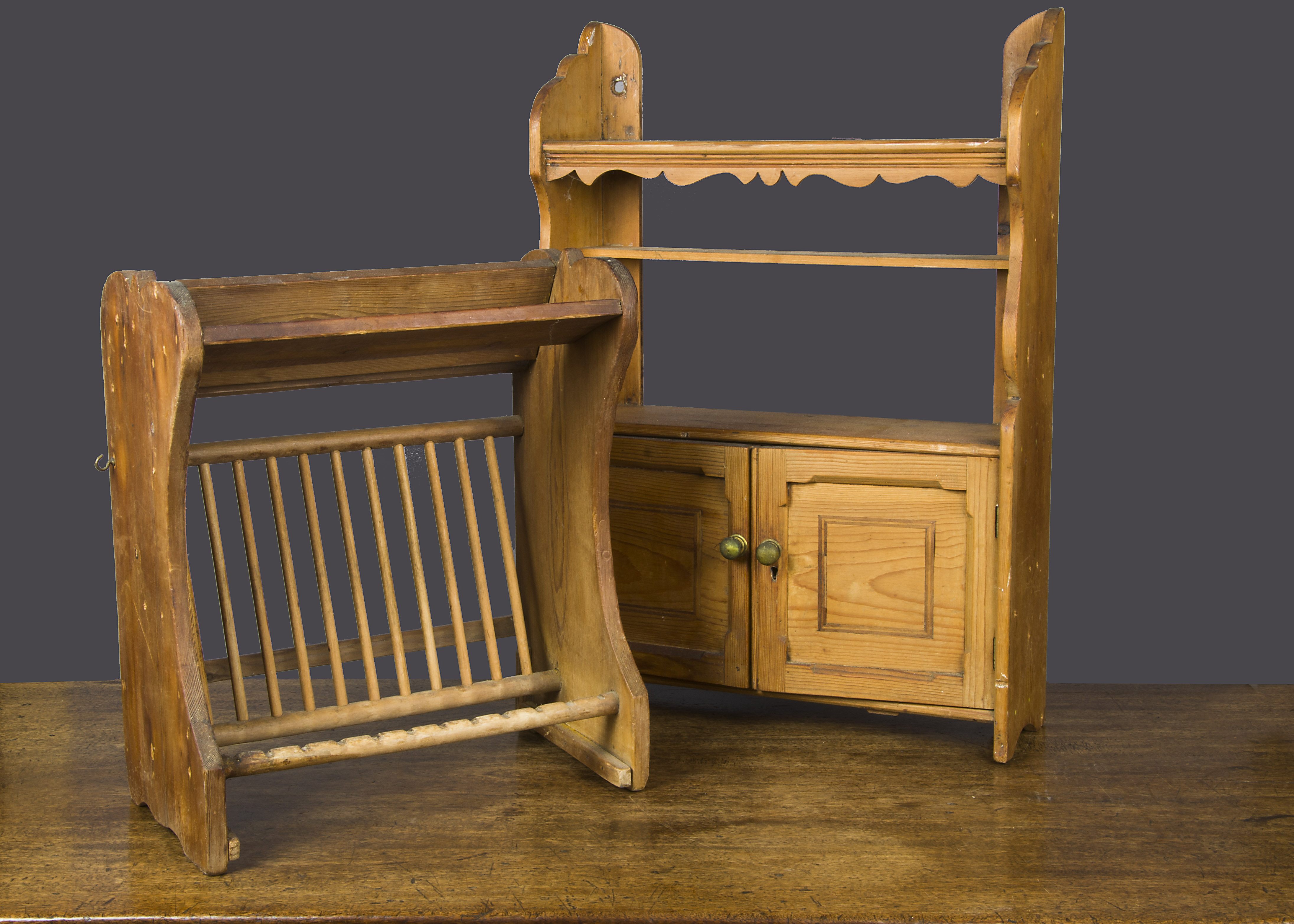 A pine draining rack, for plates, cups and cutlery —17in. (43cm.) high; and a pine hanging shelf