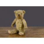 A small 1930s Chiltern teddy bear, with golden mohair, clear and black glass eyes, pronounced