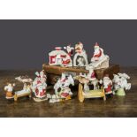 Bisque Father Christmas cake decorations, a Father Christmas stuffing a stocking at the bottom of