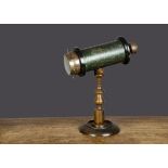 A late 19th Century kaleidoscope, green lacquered tinplate barrel with ebonised and brass ends,