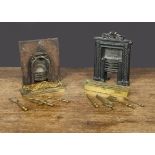 Two cast-iron sample fireplaces, a smooth front fireplace with arched hearth with scrolling