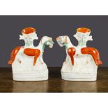 A pair of Staffordshire red and white Setter gun dogs flat-back spill holders, each holding a