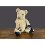 A Chiltern Cubby teddy bear 1930s, with pale blue wool plush, remains of black stitched nose and