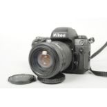 A Nikon F100 SLR Camera, serial no. 2 229 019, body G-VG, nick to top of prism, slight handling wear