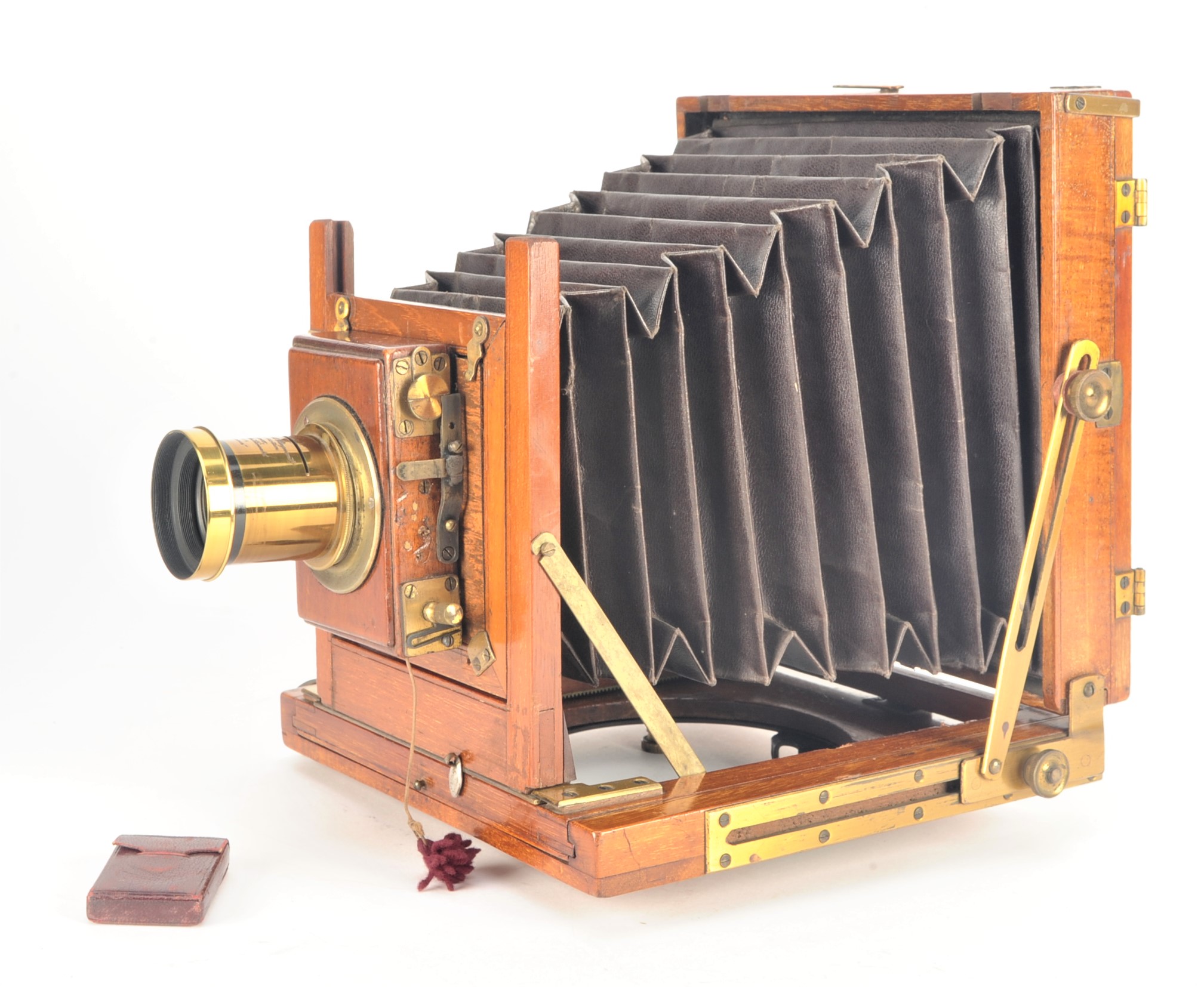 An early 20th Century mahogany and brass half-plate Field Camera, with roller-blind shutter and