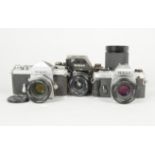 Three Nikon SLR Cameras, a Nikon F eye level, serial no 6775578, body F, brassing to edges, ding