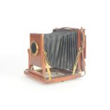 An early 20th Century mahogany and brass half-plate Thornton-Pickard 'Amber' Field Camera, with