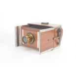 An early 20th Century teak and aluminium half-plate Shew Aluminium Xit-type Camera, unmarked, with